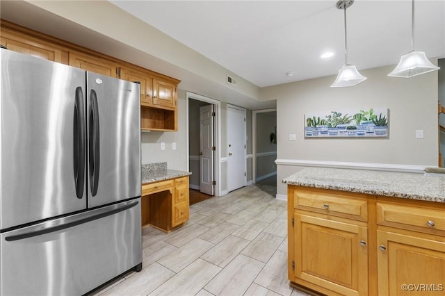 15210 Powell Grove Rd, Midlothian, VA 23112 - kitchen featuring freestanding refrigerator, pendant lighting, and light stone countertops