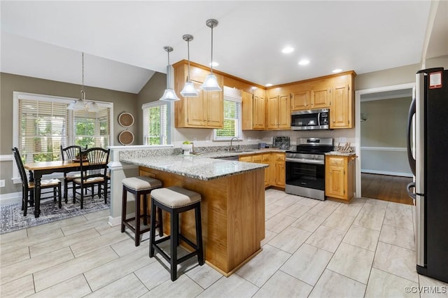 15210 Powell Grove Rd, Midlothian, VA 23112 - kitchen with stainless steel appliances, a peninsula, a breakfast bar area, light stone countertops, and decorative light fixtures