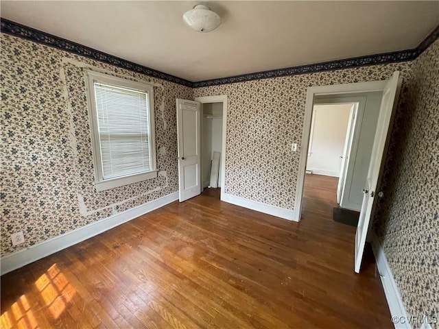 737 Jefferson Pl, Petersburg, VA 23803 - empty room featuring wood finished floors, baseboards, and wallpapered walls