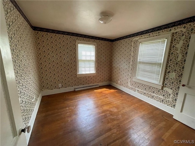 737 Jefferson Pl, Petersburg, VA 23803 - unfurnished room featuring wood finished floors, wallpapered walls, a baseboard heating unit, and baseboards