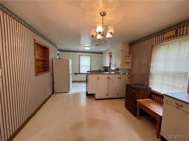 737 Jefferson Pl, Petersburg, VA 23803 - kitchen featuring freestanding refrigerator, open shelves, wallpapered walls, light floors, and a chandelier