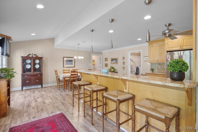 532 Fords Rd, Manakin Sabot, VA 23103 - kitchen featuring freestanding refrigerator, light brown cabinets, a breakfast bar area, baseboards, and light wood-style floors