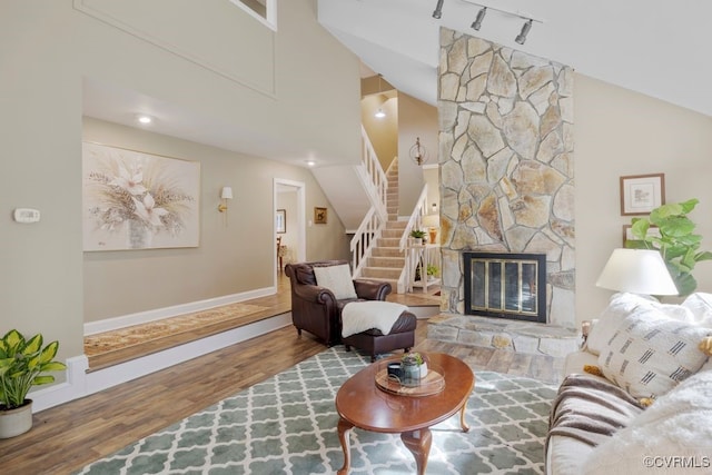 532 Fords Rd, Manakin Sabot, VA 23103 - living area with wood finished floors, stairs, rail lighting, a stone fireplace, and baseboards