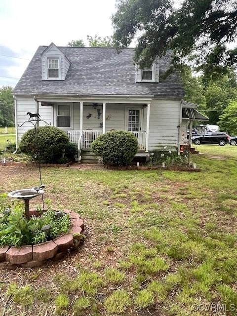 586 Mussel Swamp Rd, Essex, VA 22560 - cape cod-style house with a porch, a front yard, and a shingled roof