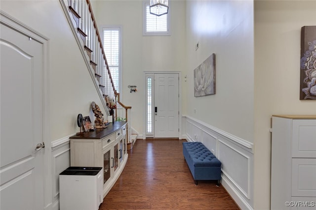 11715 Triple Notch Ter, Henrico, VA 23233 - foyer with a wainscoted wall, dark wood-style floors, stairs, a towering ceiling, and a decorative wall