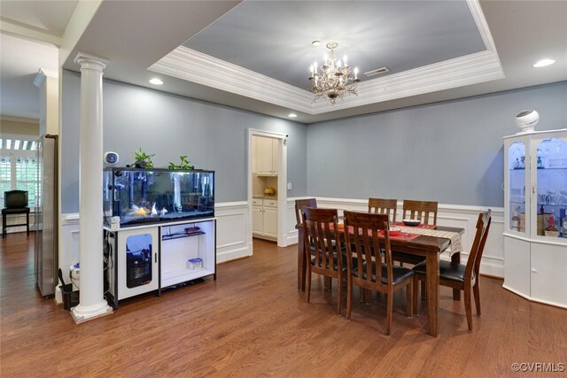 11715 Triple Notch Ter, Henrico, VA 23233 - dining space with ornamental molding, a tray ceiling, ornate columns, a chandelier, and wood finished floors