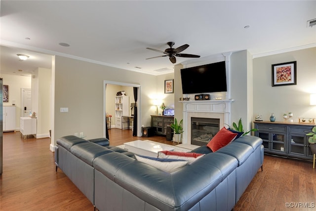 11715 Triple Notch Ter, Henrico, VA 23233 - living area featuring ceiling fan, ornamental molding, wood finished floors, and a glass covered fireplace
