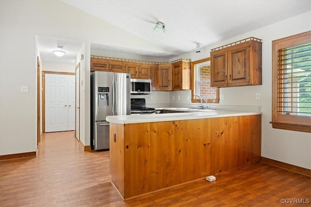 3786 Donavon Mill Ct, Powhatan, VA 23139 - kitchen with stainless steel appliances, brown cabinets, a sink, lofted ceiling, and wood finished floors