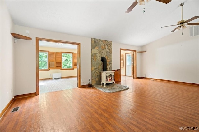 3786 Donavon Mill Ct, Powhatan, VA 23139 - unfurnished living room with a wood stove, wood finished floors, a ceiling fan, baseboards, and lofted ceiling