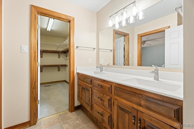3786 Donavon Mill Ct, Powhatan, VA 23139 - bathroom with double vanity, a ceiling fan, baseboards, a spacious closet, and tile patterned flooring