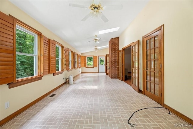 3786 Donavon Mill Ct, Powhatan, VA 23139 - hall featuring brick patterned flooring, vaulted ceiling, baseboards, a skylight, and plenty of natural light