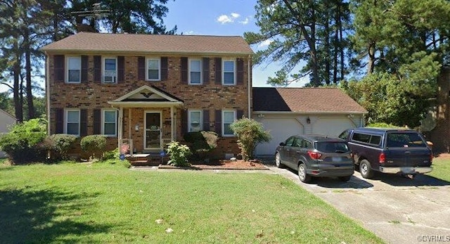 237 Greenwood Dr, Petersburg, VA 23805 - colonial house with driveway, an attached garage, a front yard, and brick siding