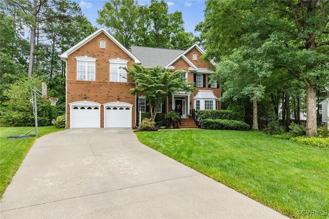 11601 Shadow Run Ln, Glen Allen, VA 23059 - georgian-style home with driveway, a garage, a front lawn, and brick siding