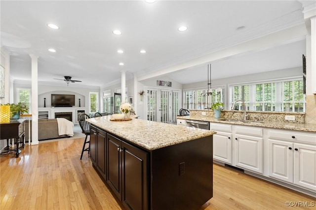 11601 Shadow Run Ln, Glen Allen, VA 23059 - kitchen with a sink, dishwasher, a ceiling fan, white cabinetry, and a fireplace