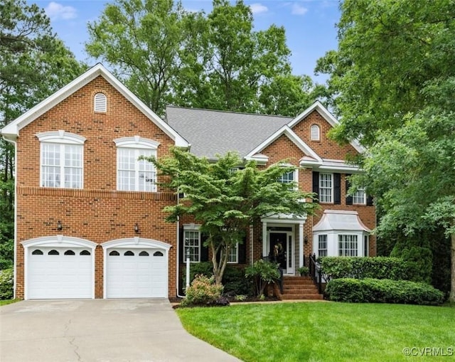 11601 Shadow Run Ln, Glen Allen, VA 23059 - colonial inspired home with driveway, an attached garage, a front yard, and brick siding