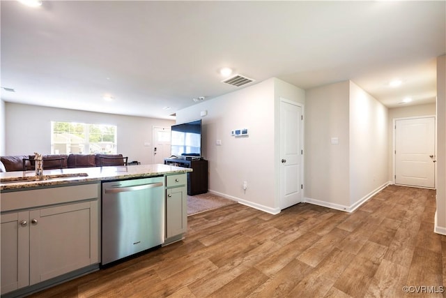 3612 Roselawn Ter, Hopewell, VA 23860 - kitchen with stainless steel dishwasher, light wood-style flooring, a sink, open floor plan, and baseboards