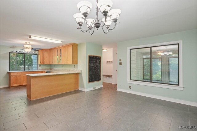 5910 Harbourwood Pl, Chesterfield, VA 23112 - kitchen with a chandelier, light countertops, baseboards, glass insert cabinets, and a peninsula