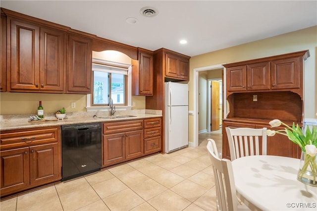 5441 Claridge Dr, Chesterfield, VA 23832 - kitchen featuring black dishwasher, freestanding refrigerator, a sink, light tile patterned floors, and brown cabinetry