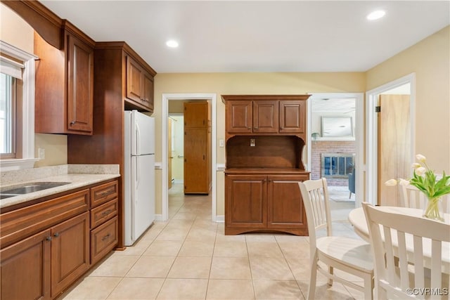5441 Claridge Dr, Chesterfield, VA 23832 - kitchen featuring freestanding refrigerator, light tile patterned floors, recessed lighting, a sink, and light stone counters