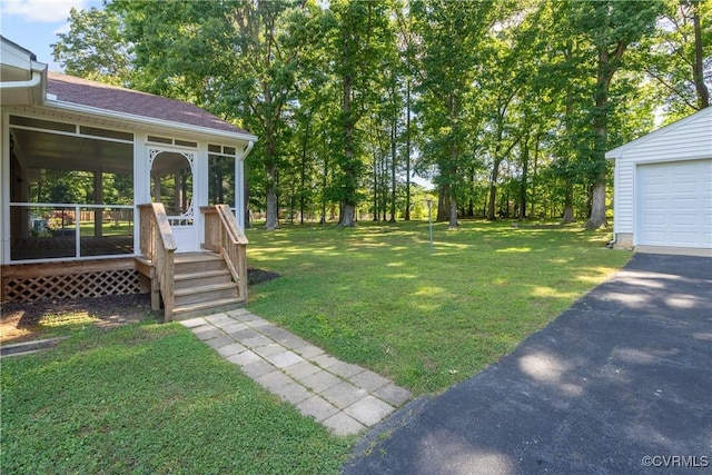 5441 Claridge Dr, Chesterfield, VA 23832 - view of green lawn with a sunroom, driveway, and a garage