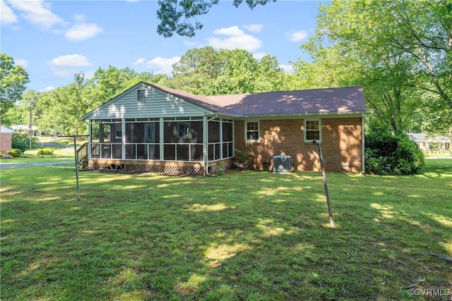 5441 Claridge Dr, Chesterfield, VA 23832 - rear view of property featuring a sunroom, a yard, central AC unit, and brick siding