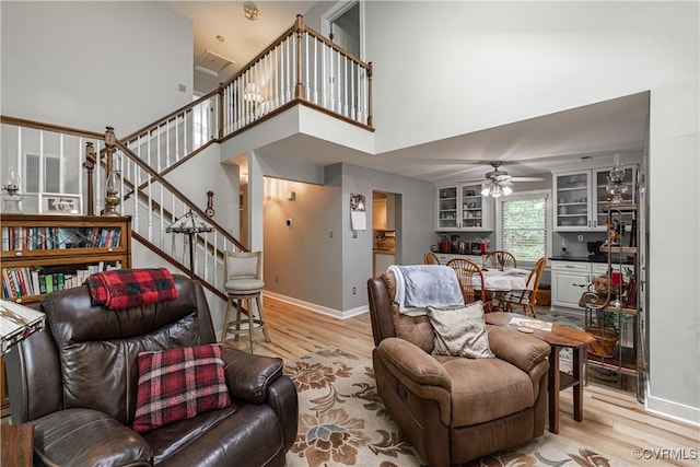 3909 Foxfield Ter, Henrico, VA 23233 - living area with a ceiling fan, light wood-type flooring, stairs, baseboards, and a towering ceiling