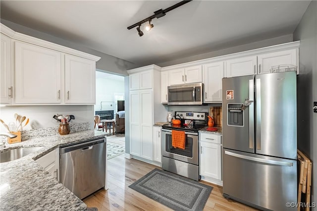 3909 Foxfield Ter, Henrico, VA 23233 - kitchen with appliances with stainless steel finishes, a sink, white cabinets, light stone counters, and light wood-style floors