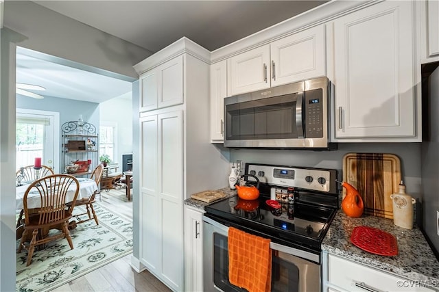 3909 Foxfield Ter, Henrico, VA 23233 - kitchen with stainless steel appliances, white cabinetry, wood finished floors, and light stone countertops