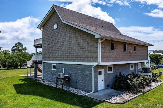 224 Oyster Creek Dr, White Stone, VA 22578 - view of home's exterior featuring a yard, stairs, roof with shingles, and central AC unit