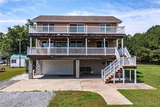 224 Oyster Creek Dr, White Stone, VA 22578 - view of front of house featuring driveway, a garage, a front lawn, and a porch