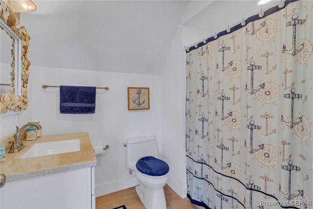 224 Oyster Creek Dr, White Stone, VA 22578 - full bath featuring vanity, toilet, lofted ceiling, wood finished floors, and baseboards