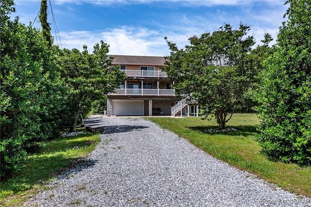 224 Oyster Creek Dr, White Stone, VA 22578 - view of front of property with gravel driveway, stairs, a garage, and a front yard