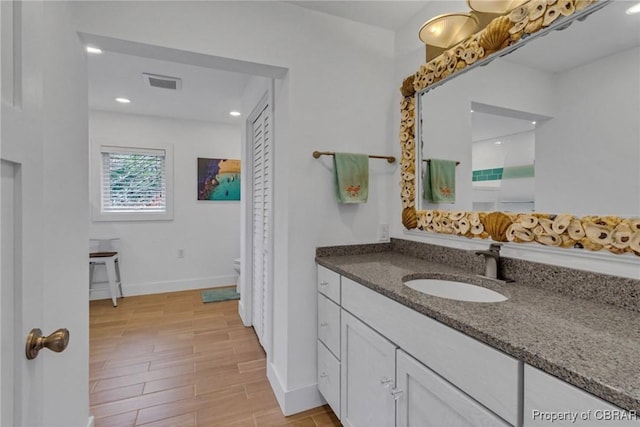 224 Oyster Creek Dr, White Stone, VA 22578 - full bath featuring vanity, baseboards, toilet, wood finished floors, and recessed lighting