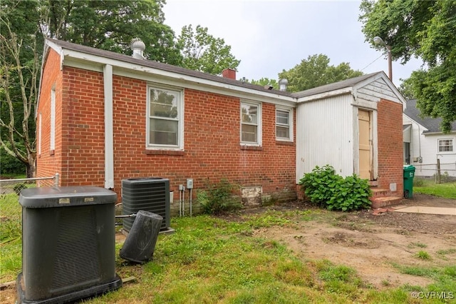 4 W Jerald St, Henrico, VA 23075 - view of side of property featuring central air condition unit, brick siding, a chimney, and entry steps