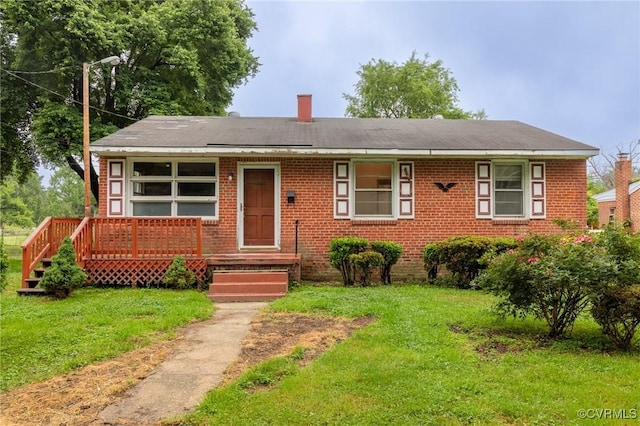 4 W Jerald St, Henrico, VA 23075 - view of front facade featuring a front lawn, brick siding, and a chimney