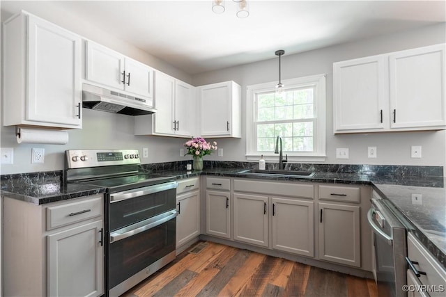 3206 Ramsey Dr, Chester, VA 23831 - kitchen with stainless steel appliances, under cabinet range hood, a sink, dark wood finished floors, and pendant lighting