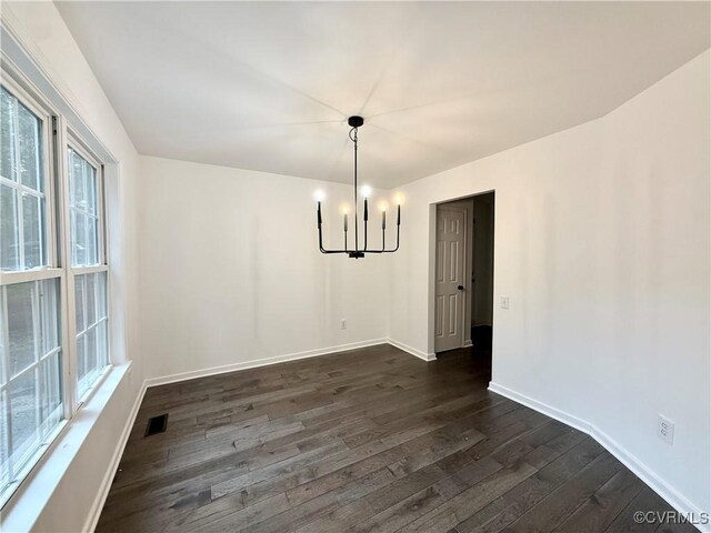 4608 Stoney Creek Pkwy, Chester, VA 23831 - unfurnished dining area with a chandelier, dark wood-type flooring, and baseboards