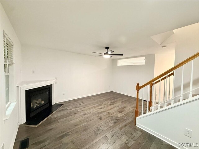 4608 Stoney Creek Pkwy, Chester, VA 23831 - unfurnished living room with ceiling fan, stairs, dark wood-type flooring, a glass covered fireplace, and baseboards