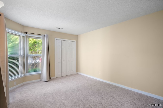 2615 Towngate Ct, Henrico, VA 23233 - unfurnished bedroom featuring carpet floors, a textured ceiling, baseboards, and a closet