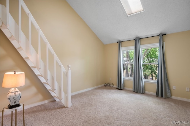 2615 Towngate Ct, Henrico, VA 23233 - carpeted empty room with stairs, vaulted ceiling, baseboards, and a textured ceiling