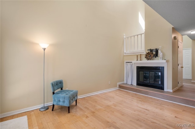 2615 Towngate Ct, Henrico, VA 23233 - unfurnished room featuring wood finished floors, a glass covered fireplace, and baseboards