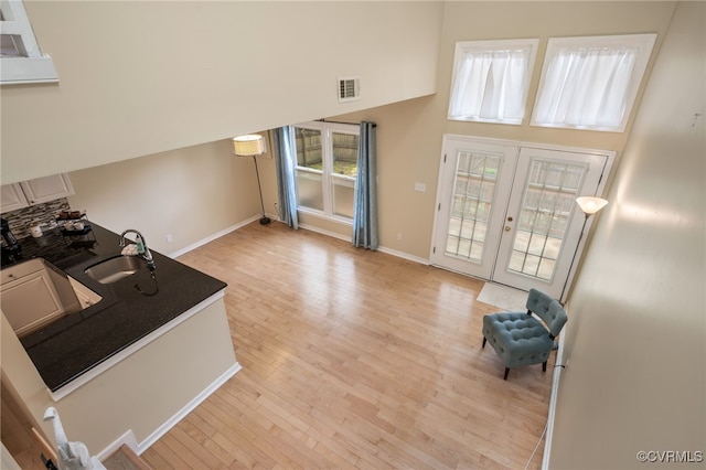 2615 Towngate Ct, Henrico, VA 23233 - kitchen with a sink, french doors, light wood-style floors, plenty of natural light, and a high ceiling