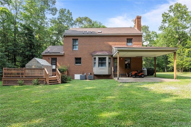 325 Hamlet Rd, Manakin Sabot, VA 23103 - back of house featuring a greenhouse, a chimney, brick siding, a yard, and a carport