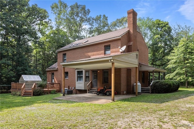 325 Hamlet Rd, Manakin Sabot, VA 23103 - rear view of house featuring an exterior structure, brick siding, a lawn, an outbuilding, and a chimney