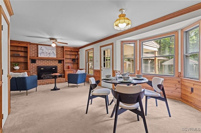 325 Hamlet Rd, Manakin Sabot, VA 23103 - dining area with ornamental molding, light colored carpet, built in shelves, a fireplace, and ceiling fan