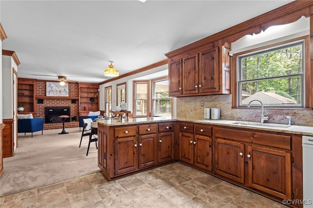 325 Hamlet Rd, Manakin Sabot, VA 23103 - kitchen with a fireplace, a peninsula, crown molding, ceiling fan, and light stone countertops