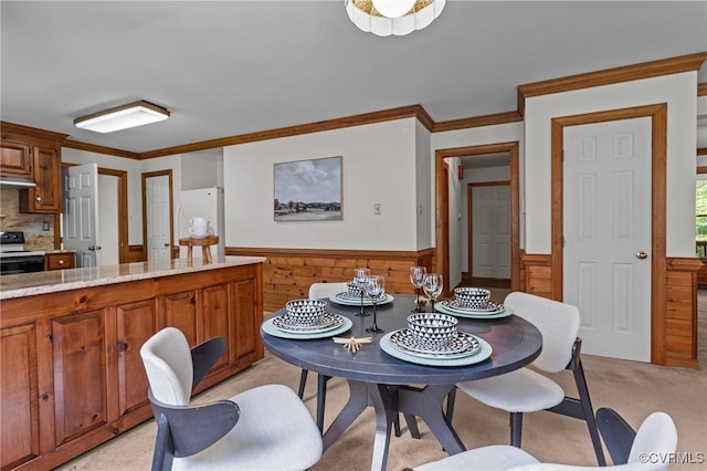 325 Hamlet Rd, Manakin Sabot, VA 23103 - dining space featuring a wainscoted wall, crown molding, wooden walls, and light colored carpet