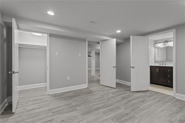 2920 Hawthorne Ave, Richmond, VA 23222 - unfurnished bedroom featuring a sink, light wood-style floors, baseboards, recessed lighting, and a spacious closet