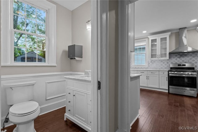 2920 Hawthorne Ave, Richmond, VA 23222 - bathroom with vanity, wood finished floors, toilet, a wainscoted wall, and backsplash