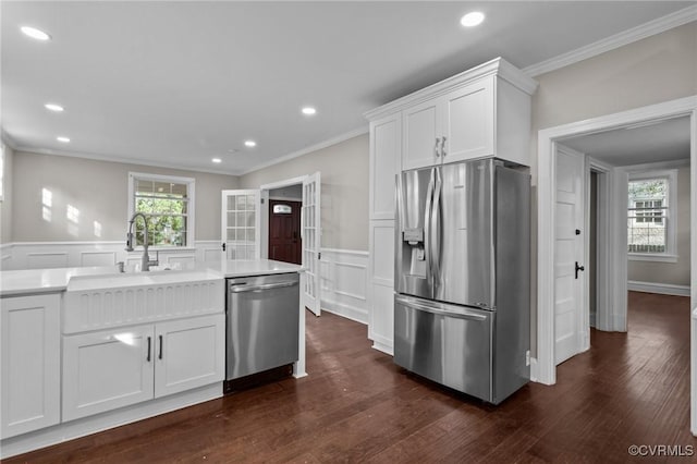 2920 Hawthorne Ave, Richmond, VA 23222 - kitchen with appliances with stainless steel finishes, crown molding, white cabinets, a wainscoted wall, and recessed lighting